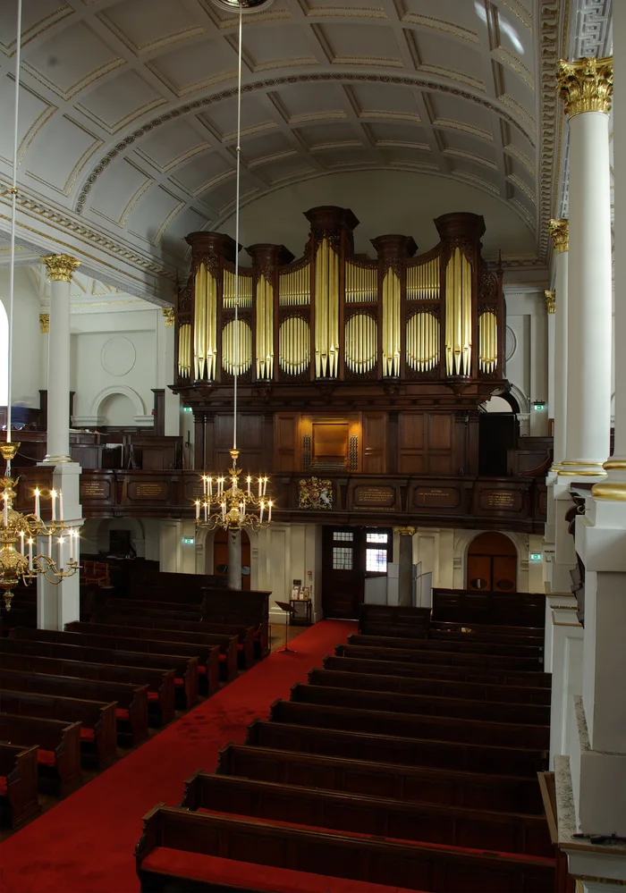 The gallery organ of St George’s, Hanover Square, London, seen from the nave: gilded façade pipes above a dark wooden case.